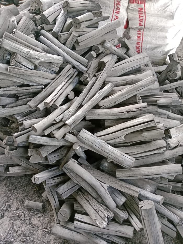 Pile of binchotan white charcoal sticks with their pale grey ash coating